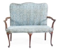 A George II walnut settee, circa 1750, with a rectangular padded back  A George II walnut