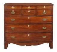 A George IV mahogany bowfront chest of drawers, circa 1825, with ebony  A George IV mahogany