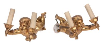 A pair of gilt metal twin light wall appliques cast as amorini, circa 1930  A pair of gilt metal