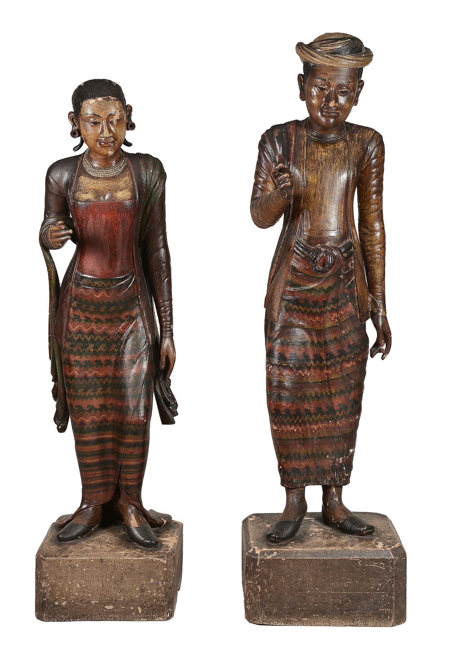 A pair of South East Asian carved and polychrome paintman and painted wood...  A pair of South