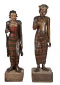 A pair of South East Asian carved and polychrome paintman and painted wood...  A pair of South