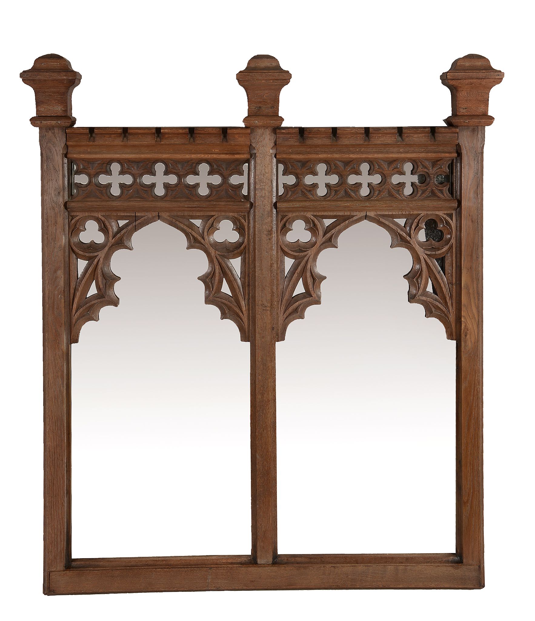 An oak wall mirror in Gothic Revival style, circa 1880 and later  An oak wall mirror in Gothic