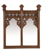 An oak wall mirror in Gothic Revival style, circa 1880 and later  An oak wall mirror in Gothic