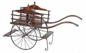 A wrought iron and beech childs twin seat cart, late 19th/ early 20th century,  A wrought iron and