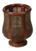 A Colonial carved satinwood and caned waste paper basket  A Colonial carved satinwood and caned