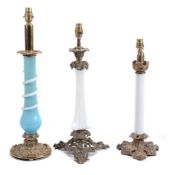 Three Victorian gilt metal and opaque glass mounted table lamps  Three Victorian gilt metal and