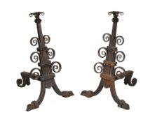 A pair of bronze mounted cast and wrought iron andirons in Arts and Crafts...  A pair of bronze