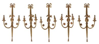A set of five gilt metal twin light wall appliques in Empire style  A set of five gilt metal twin