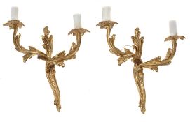 A pair of gilt metal twin light wall appliques in Louis XV style  A pair of gilt metal twin light