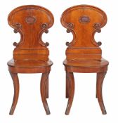A pair of George IV mahogany hall chairs , circa 1825, manner of Gillows  A pair of George IV