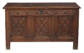 A Charles II panelled oak chest , circa 1660 the hinged lid above a triple...  A Charles II panelled