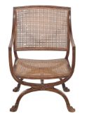 A Regency mahogany and caned X frame open armchair circa 1815 with...  A Regency mahogany and