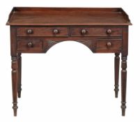 A George IV mahogany dressing table circa 1825 with a shaped three quarter...  A George IV