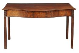 A George III mahogany serpentine front serving table circa 1770 the top with...  A George III