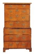 A George III walnut banded and ash chest on chest with a moulded cornice two...  A George III walnut