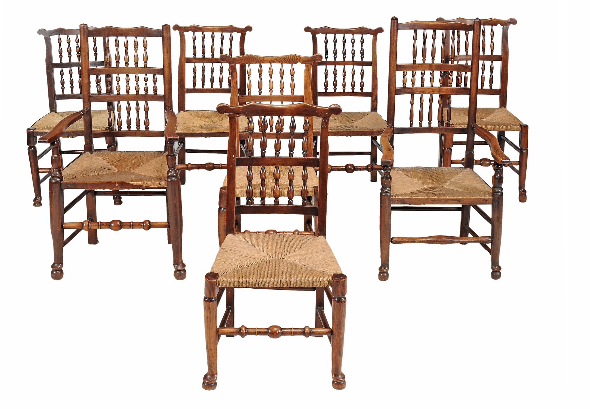 A matched set of eight elm, ash, beech and fruitwood spindle back dining...  A matched set of