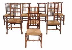 A matched set of eight elm, ash, beech and fruitwood spindle back dining...  A matched set of