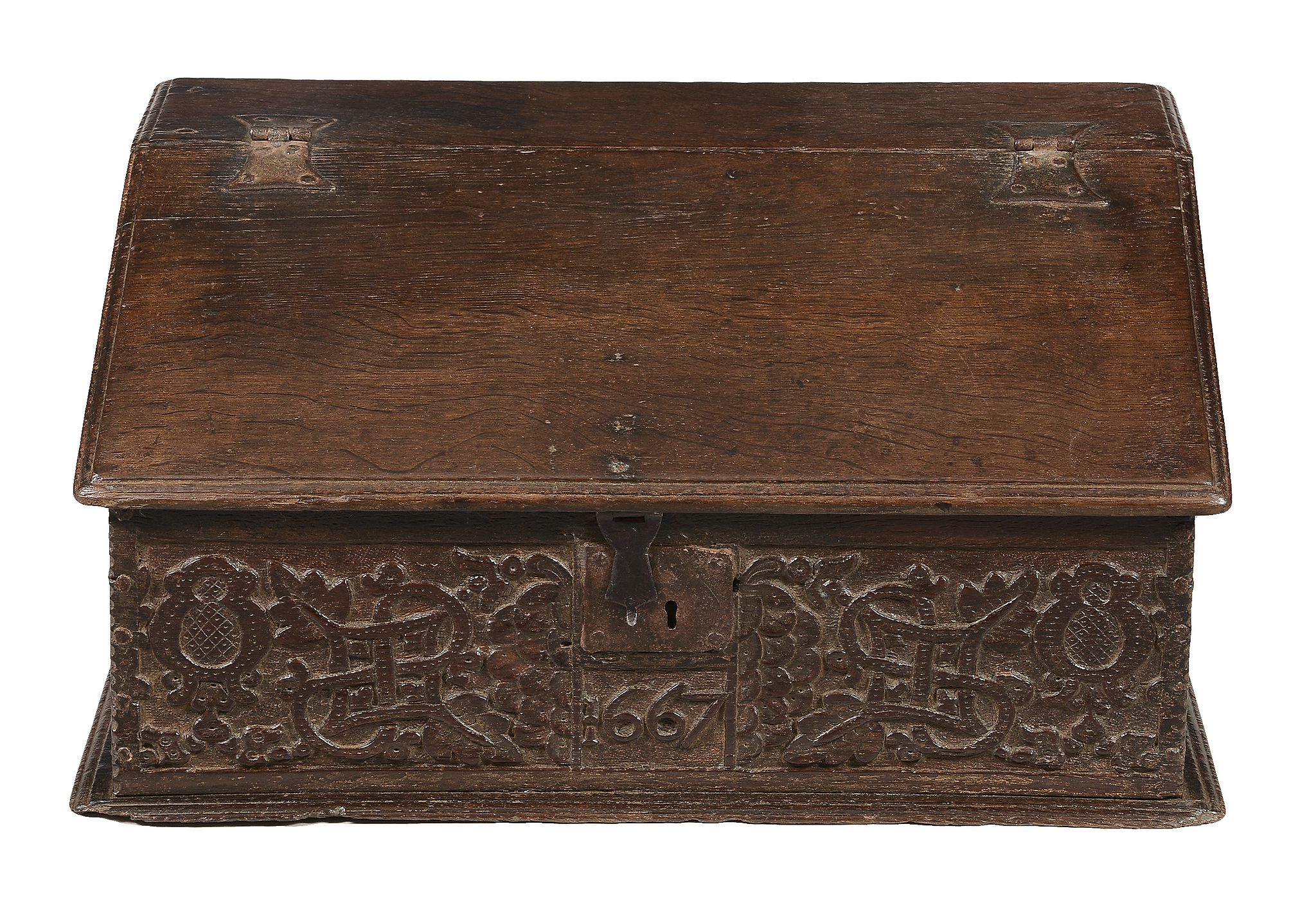 A Charles II oak bible box dated 1667 with a sloping moulded hinged top...  A Charles II oak bible