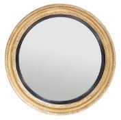 A Regency giltwood and composition circular convex wall mirror, circa 1815  A Regency giltwood and