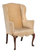 A walnut and upholstered wing armchair circa 1730 and later the rectangular...  A walnut and