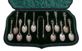 An unusual cased set of twelve Victorian silver tea spoons and a pair of... An unusual cased set