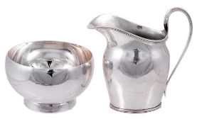 A silver cream jug by Harrods Ltd., London 1935 A silver cream jug by Harrods Ltd., London 1935,
