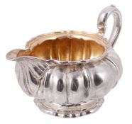 A George IV silver lobed baluster cream jug by Robert Garrard II, London 1828 A George IV silver