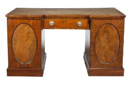 A George III mahogany desk, circa 1800, the tooled leather inset top above a... A George III