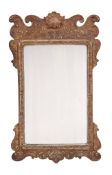 A carved and gilt composition framed wall mirror in George II style A carved and gilt composition