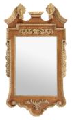 A walnut and parcel gilt wall mirror in George III style A walnut and parcel gilt wall mirror in