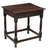 A Charles II oak side table, crca 1660, the cleated plank top above a drawer... A Charles II oak