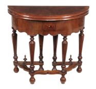 A walnut and featherbanded semi elliptical folding table in William & Mary... A walnut and