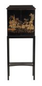 A black lacquer and gilt chinoiserie decorated cabinet on stand A black lacquer and gilt