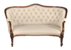 A Victorian rosewood and cream leather upholstered sofa circa 1860 A Victorian rosewood and cream