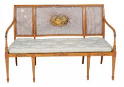 A Sheraton Revival caned sofa late 19th/early 20th Century painted with... A Sheraton Revival caned