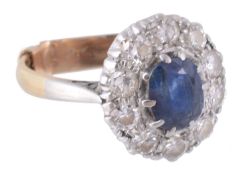 A sapphire and diamond cluster ring, the central oval shaped sapphire in a...  A sapphire and