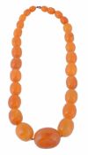 A single strand amber bead necklace, composed of twenty seven 9  A single strand amber bead