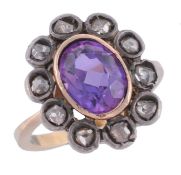 A 19th century amethyst and diamond ring, the central collet set oval shaped...  A 19th century