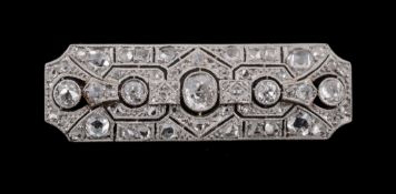 A diamond bar brooch, circa 1925, the rectangular shaped pierce panel set...  A diamond bar brooch,