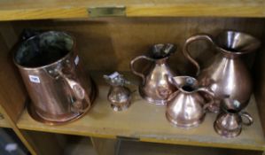 A set of four graduated copper ale jugs, stamped Trinity House London; together with a large