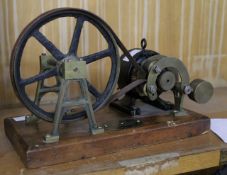 A patent `Laughton` Drive, patent No.136422 1919, set on a wooden plinth, 26cm wide. There is no