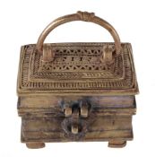 A brass casket, of rectangular outline with a hinged lid and swing handle, 10cm. There is no