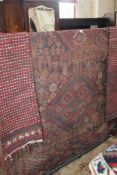 A Middle Eastern carpet and two runners.170 x 310cm. There is no condition report available on