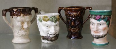 A 19th century Staffordshire pottery Bacchus mug; together with three further vessels modelled