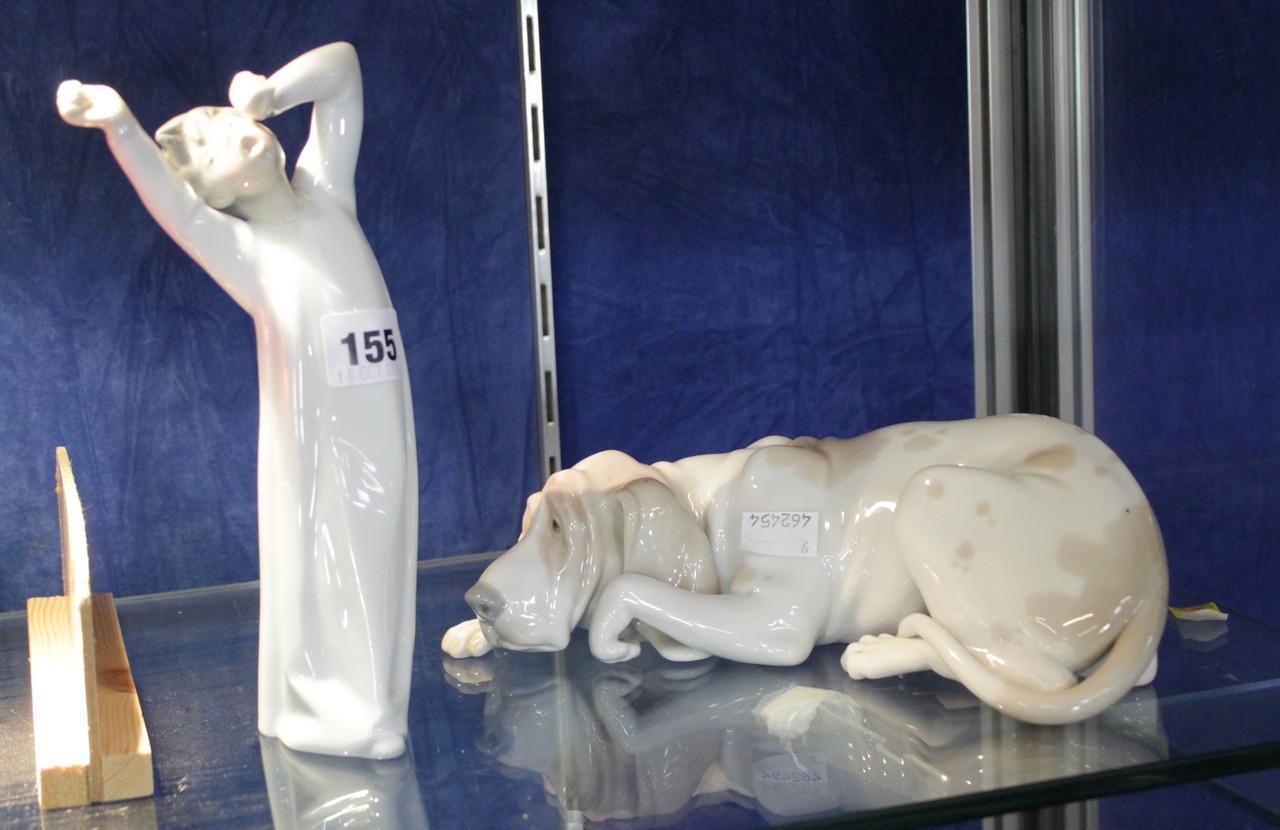 A Nao figure of a yawning boy, and a Lladro recumbent Great Dane. There is no condition report