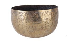 A Persian hammered brass bowl, decorated with panels of dancers, 18cm diameter. There is no