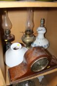 Two oil lamps, a mantle clock, and a Lladro porcelain table lamp (sold as parts). There is no