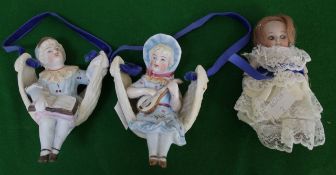 A small bisque doll and two bisque figures in baskets. There is no condition report available on