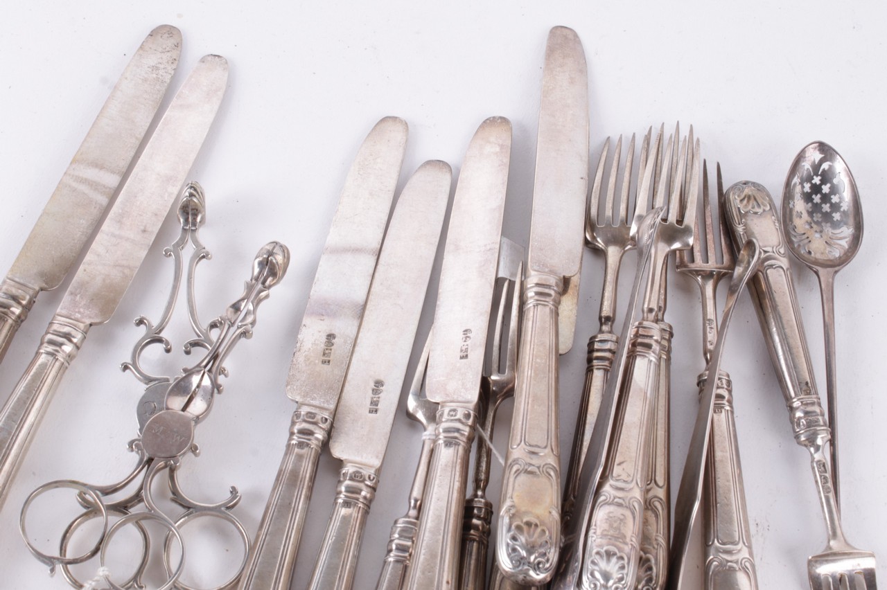 A collection of silver flatware, to include: two pairs of mid 18th century silver sugar nips, each