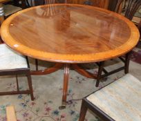 A Regency design mahogany table with crossbanded detail by William Tillman with a circular top